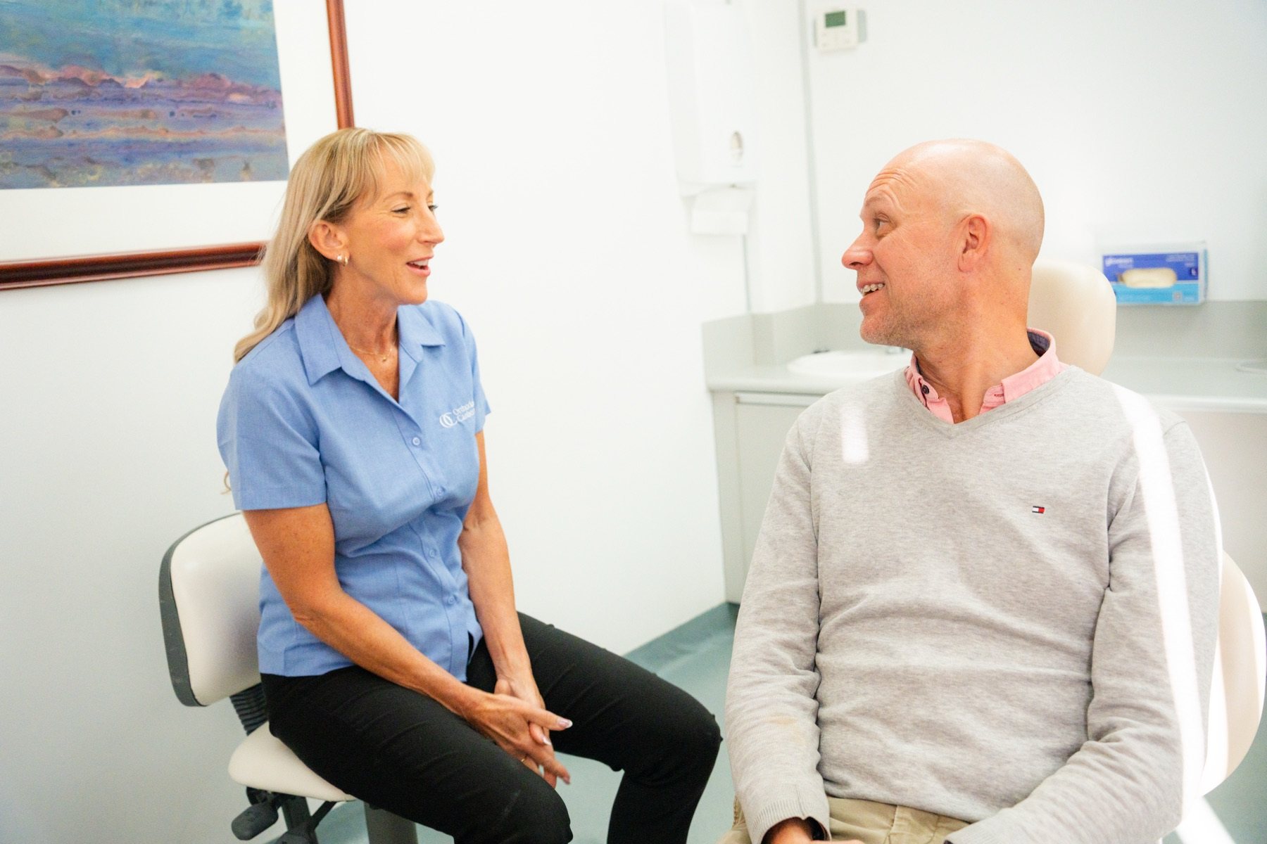 Senior clinician in conversation with an adult patient